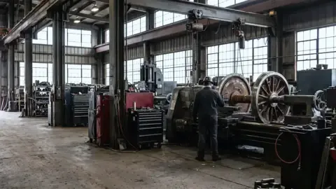A railroad locomotive wheel shop where machinists work
